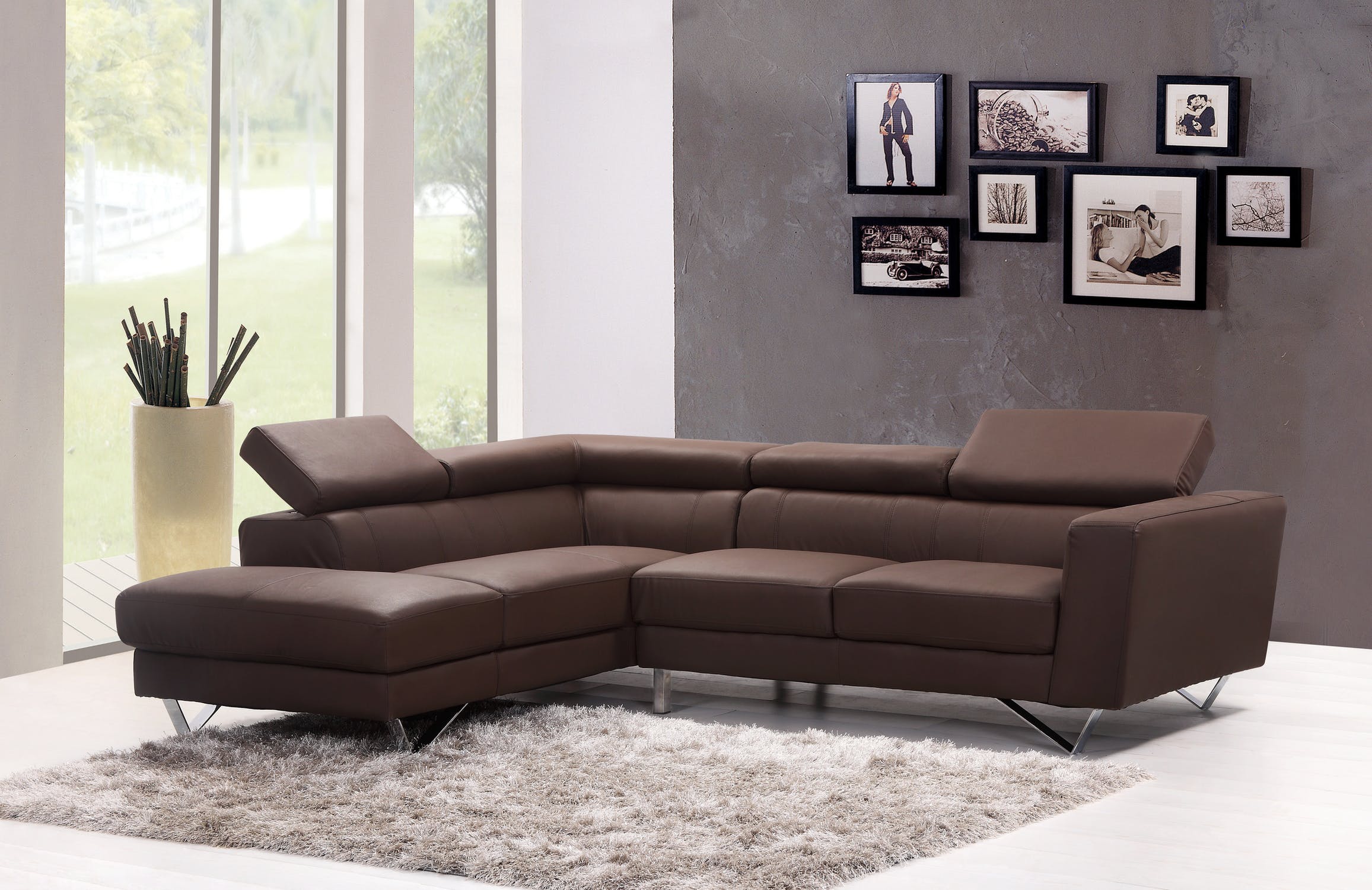 A large brown leather corner sofa with a rug