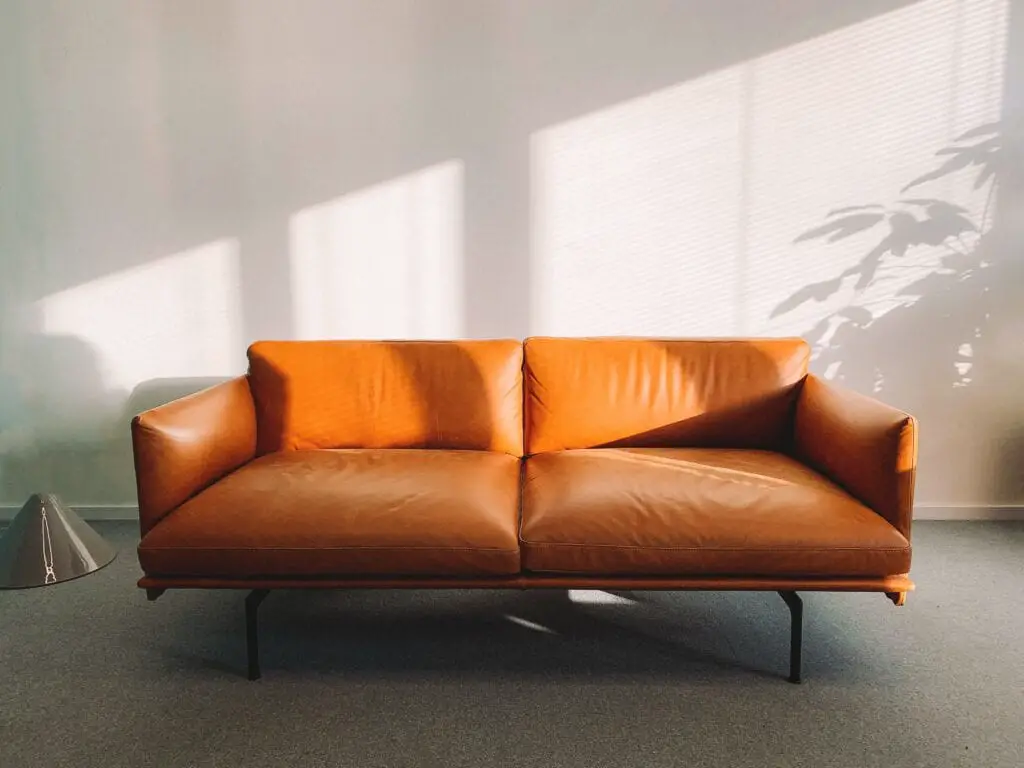 An orange leather sofa in a room