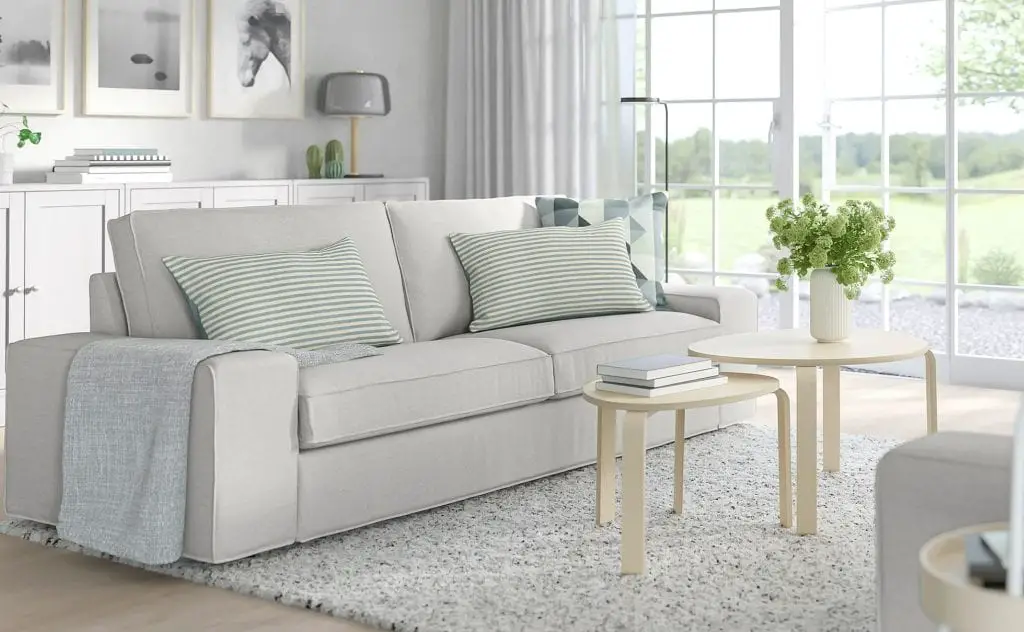 Grey fabric sofa with light coloured cushions