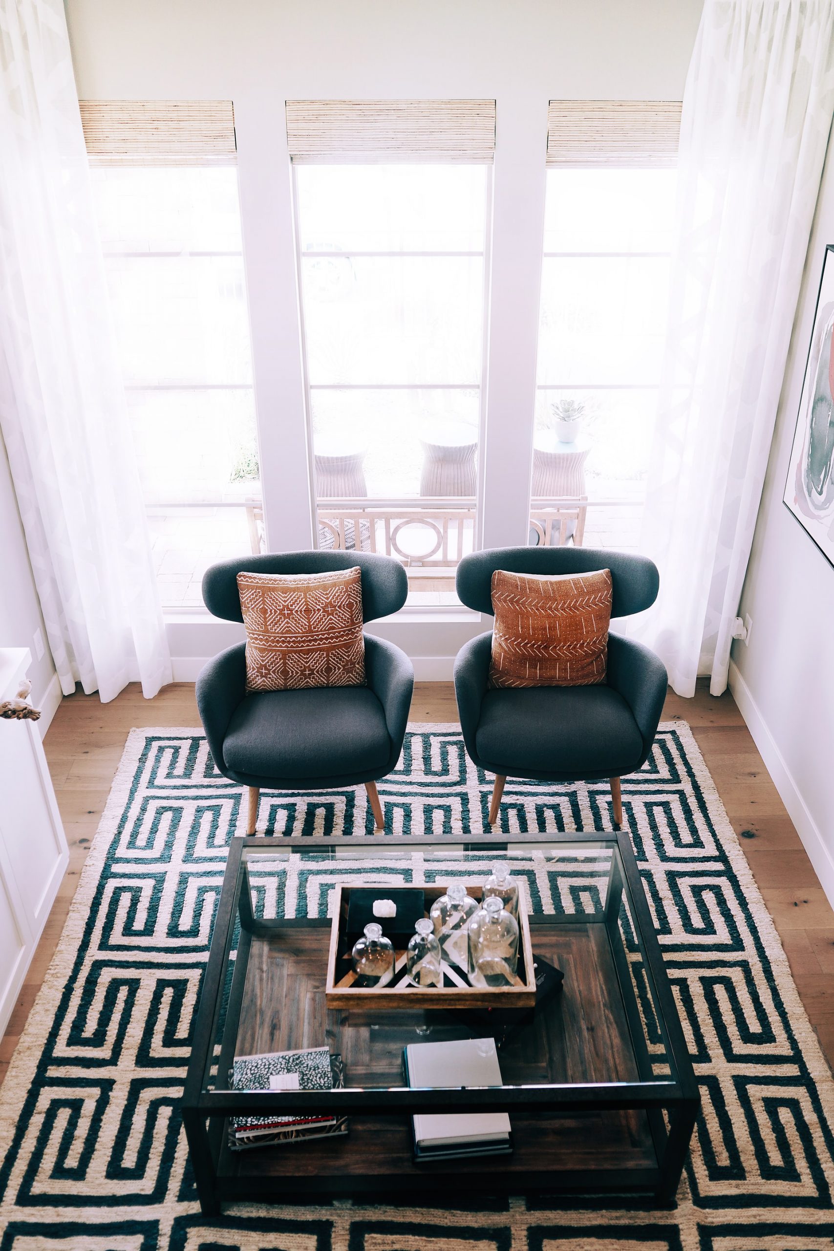 A living room with two chairs and rug
