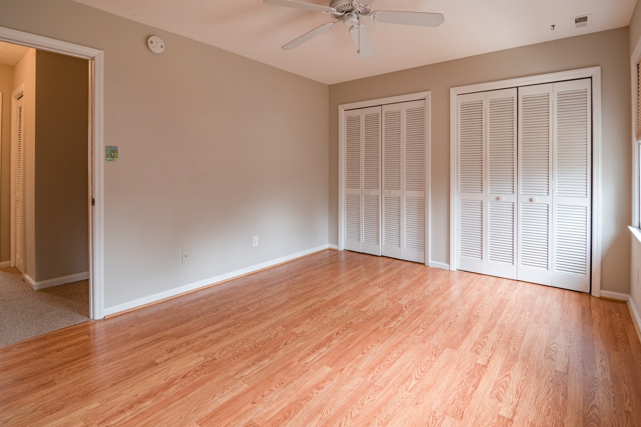 An empty room with a hardwood floor