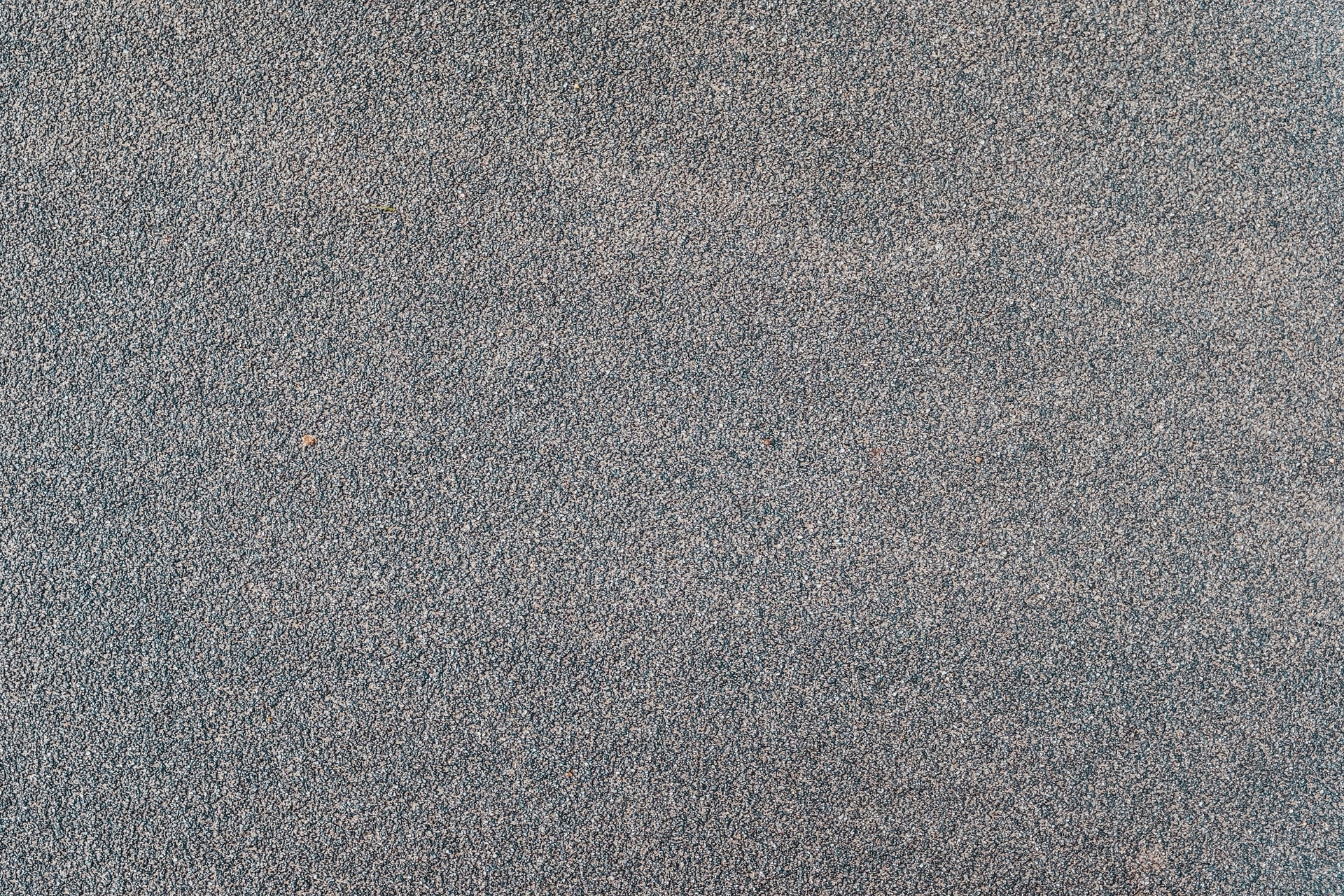A close up of a grey fibred carpet