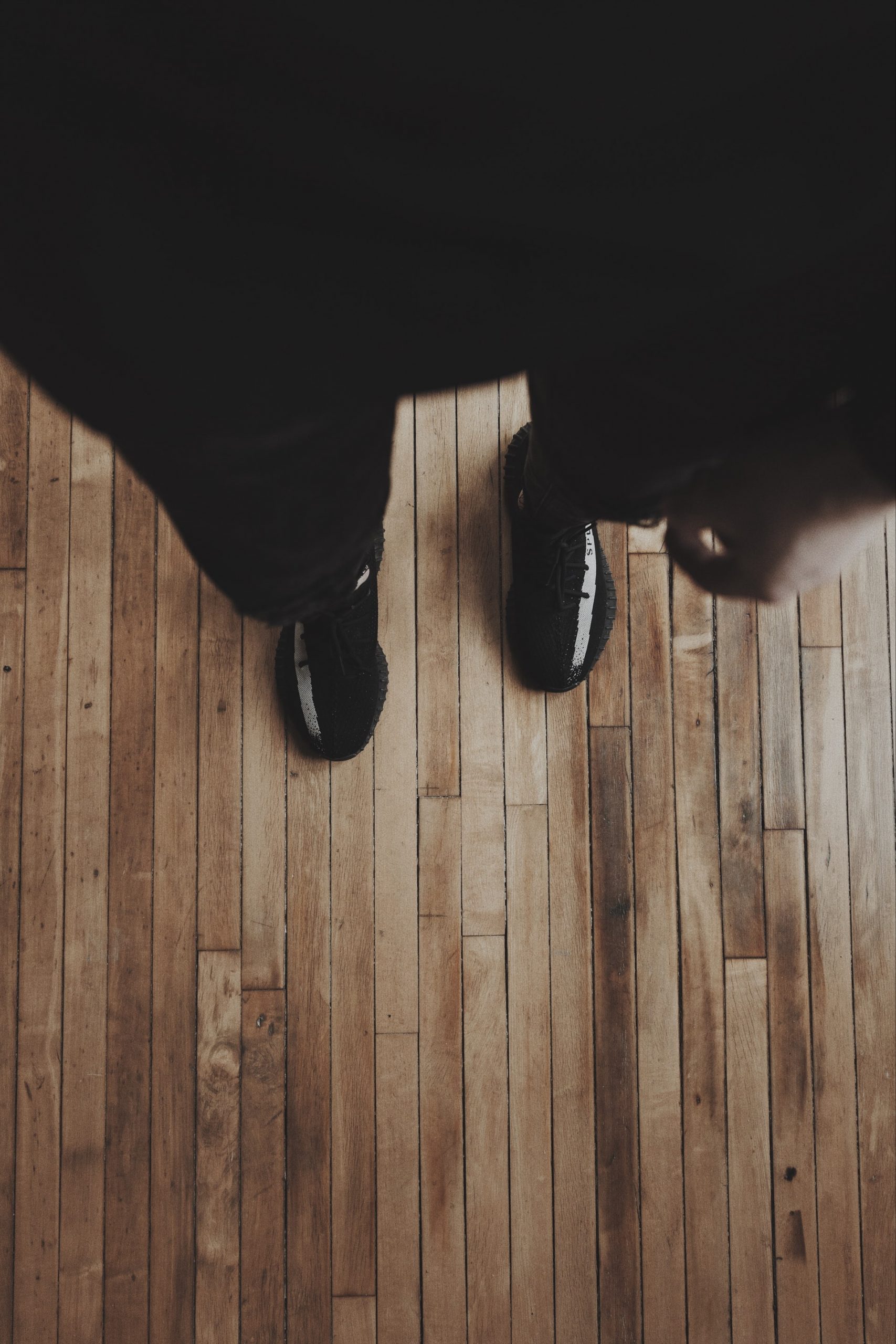 A pair of feet on a hardwood floor