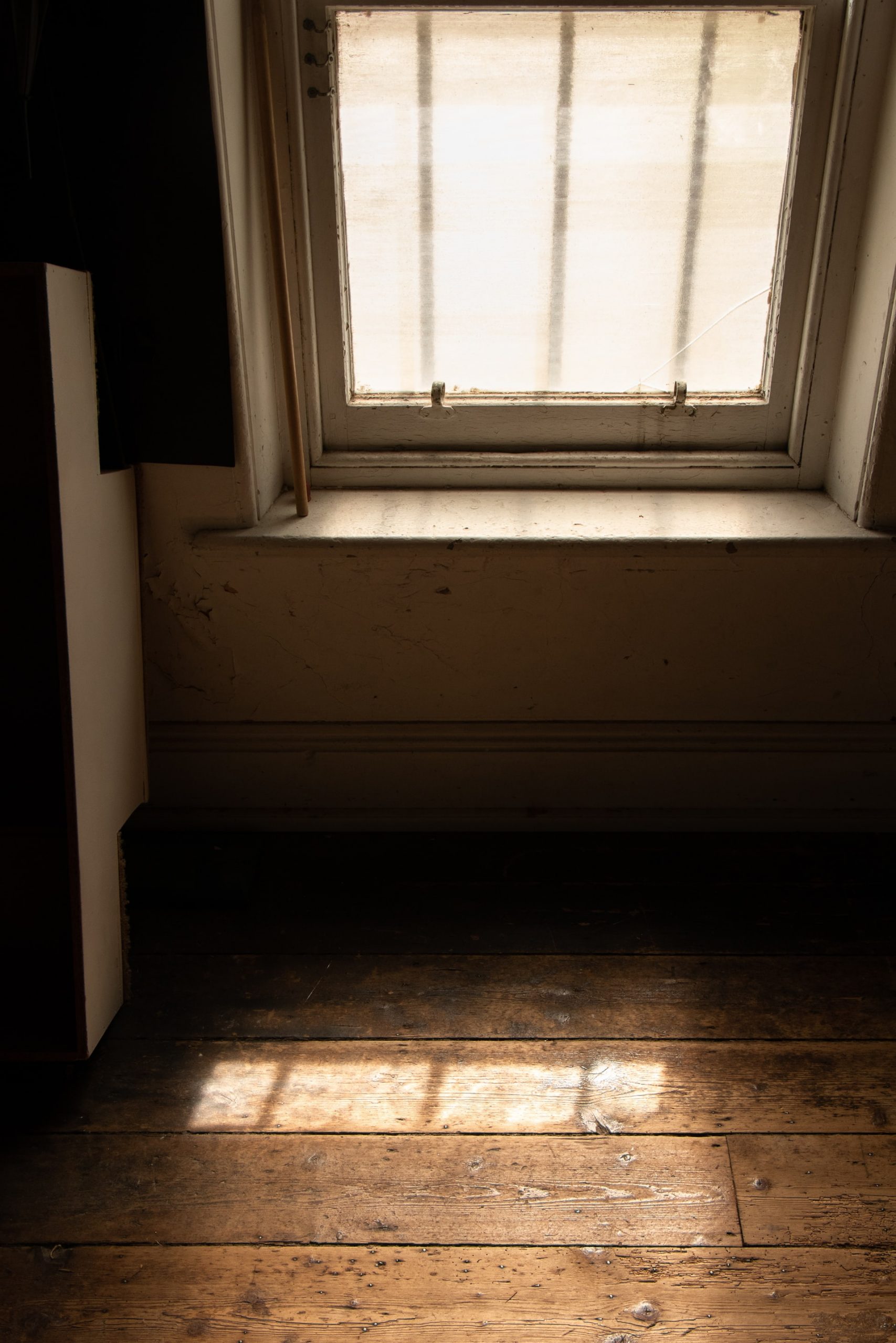 Sunlight through a window on a wood floor
