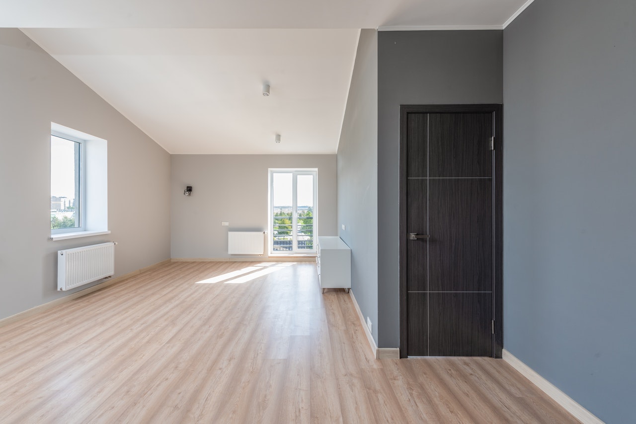 An empty room with parquet flooring