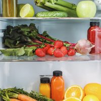 Fruit and vegetables on refrigerator shelves