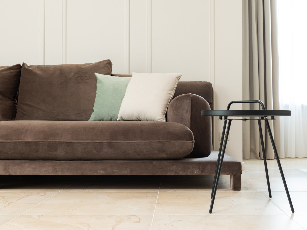 Brown sofa with white and green cushions