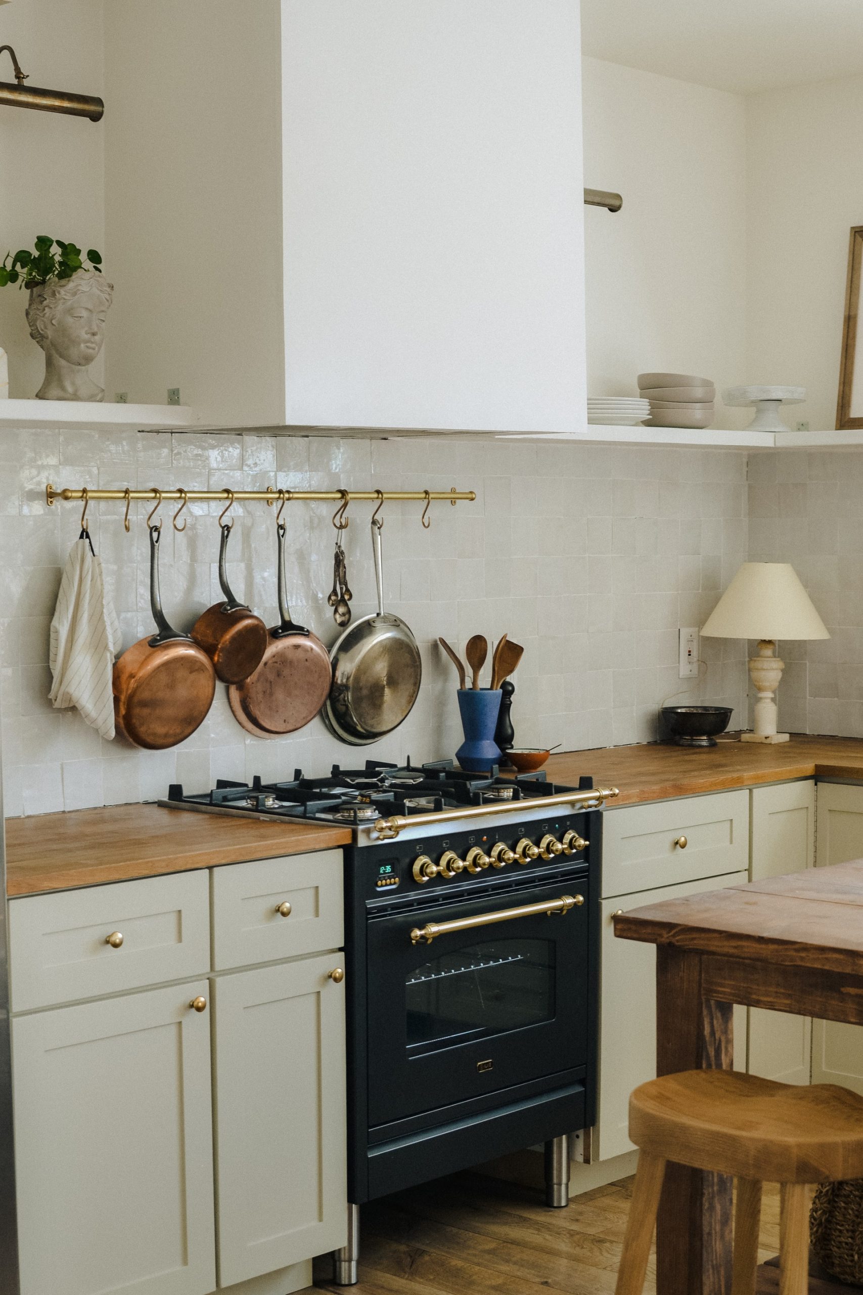 A kitchen with a black and gold oven